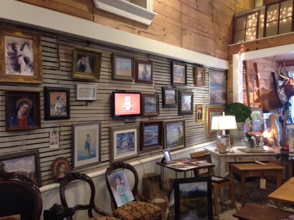 Photograph of paintings covering a wall